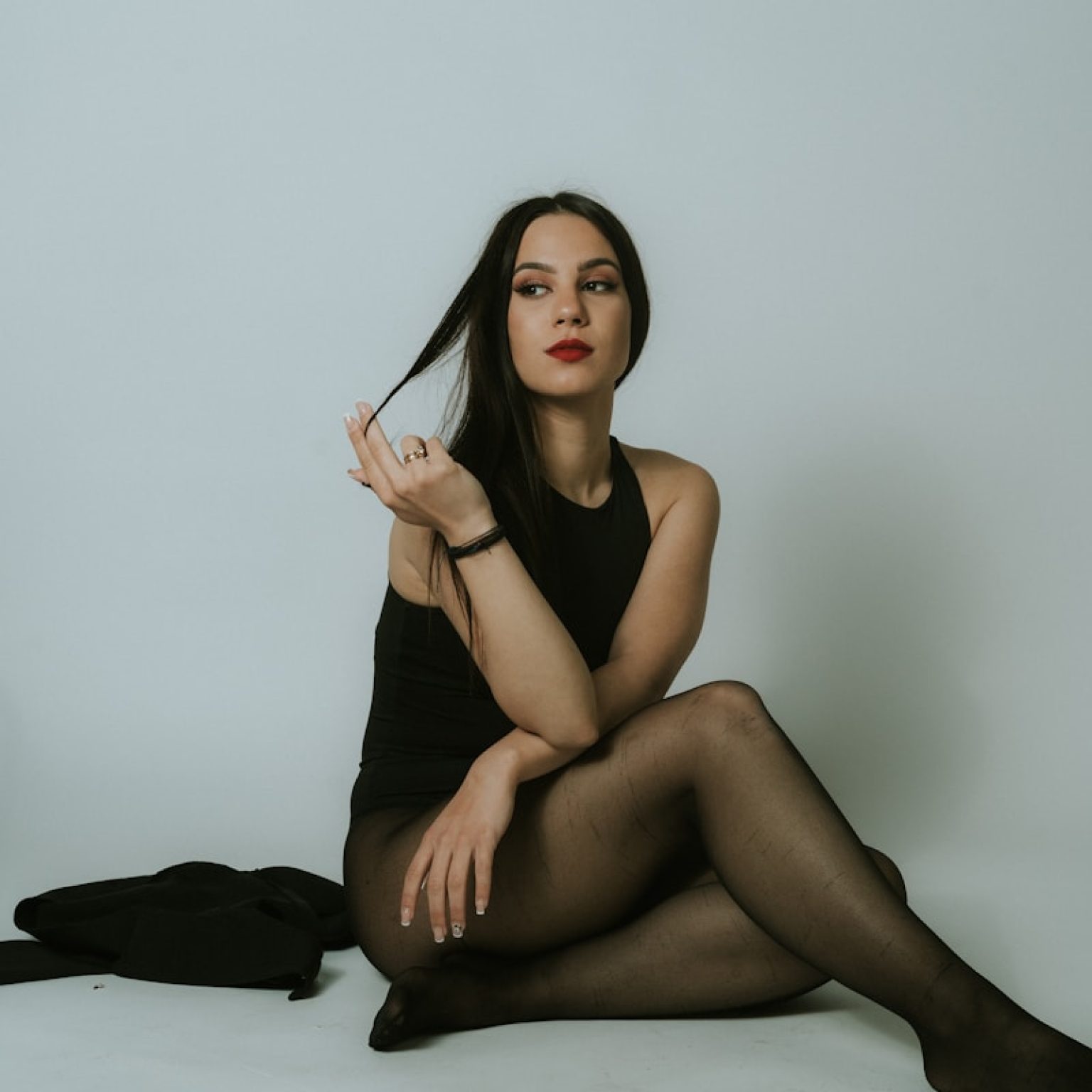 a woman sitting on the floor with her legs crossed